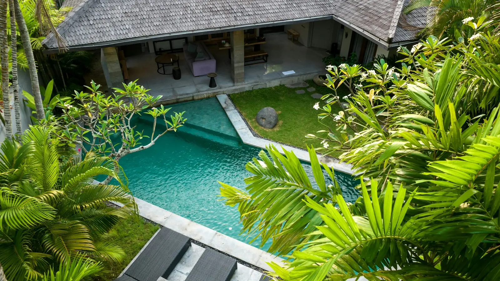 Aerial view of a Bali villa with a private pool, lawn and tropical garden in Seminyak